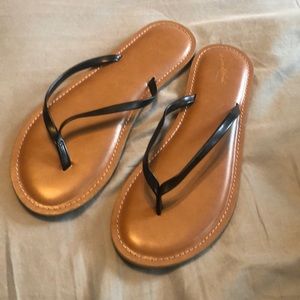 Black leather flip flops